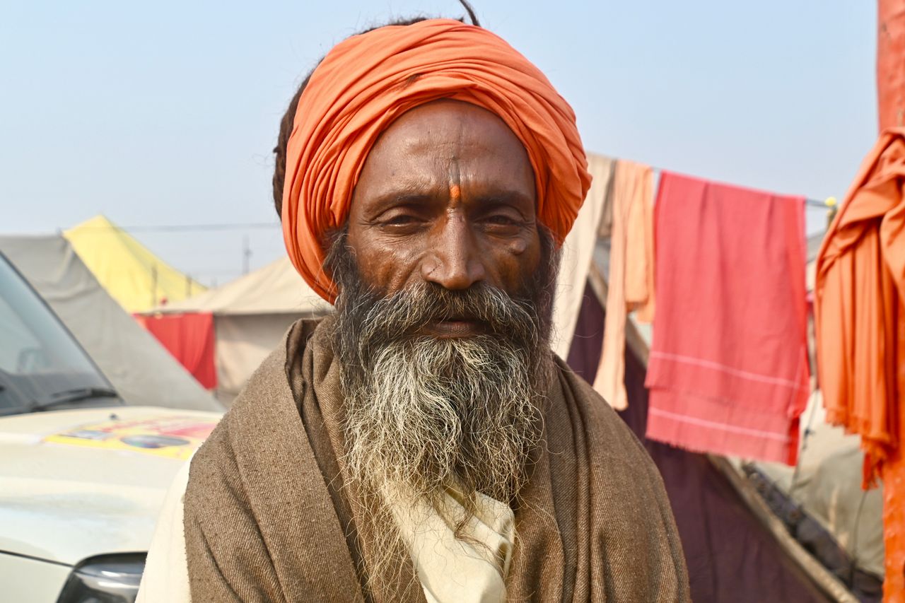 A vibrant portrait of a Sadhu with colorful attire in Prayagraj, Uttar Pradesh, India.