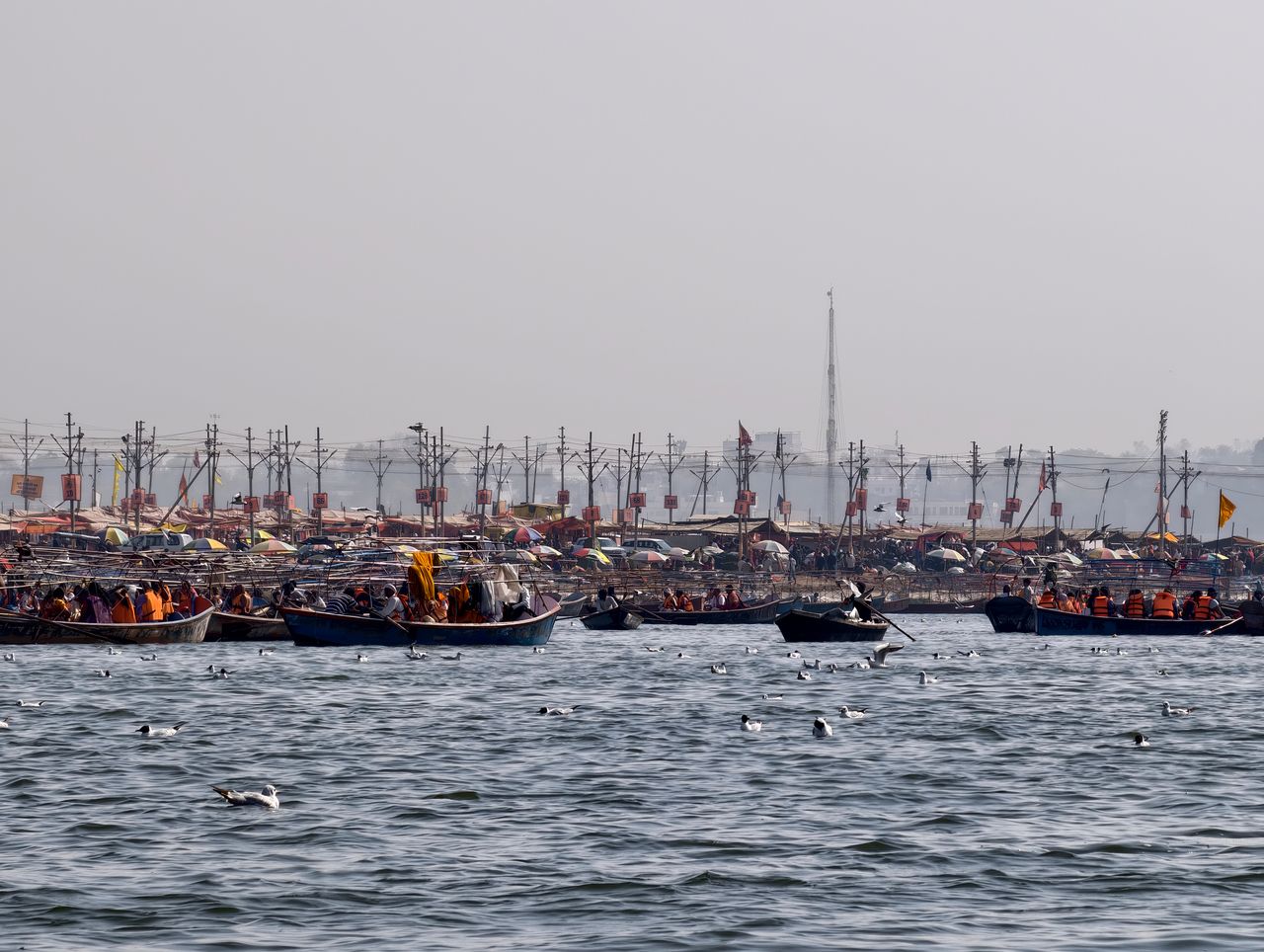 A vibrant scene of boats on the Ganges amidst Kumbh Mela festivities in Prayagraj, India.